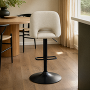 In a room | the stool at a plaster dining room's kitchen island edge, low golden afternoon light from the right