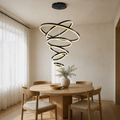 In a room | six-ring black LED chandelier cascading over a round oak dining table
