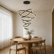 In a room | six-ring black LED chandelier cascading over a round oak dining table