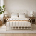 Airy room | Off-white spindle bed in a bright bedroom with oak nightstands, a plant, and linen bedding