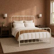 Clay corner | Off-white spindle bed from the corner with a warm clay wall, wood nightstand, and rug