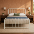 Clay room | Off-white spindle bed against a warm clay wall with brass sconces and dark nightstands