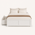 Front | Straight-on studio view of the white platform bed with its paneled footboard