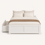 Front | Straight-on studio view of the white platform bed with its paneled footboard