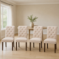 In a room | the set of four beside a round table in a warm flax dining room, bright midday light