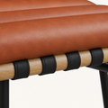 Detail | the white-oak-veneer dowel rail and black straps where they meet the seat