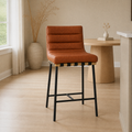 In a room | the stool at a bright flax dining room's island edge, midday light from the left