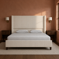 Room 3 | Front view in a clay plaster bedroom with brass sconces and a vintage rug