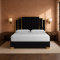 Room 3 | Front view in a clay plaster bedroom with brass sconces and a vintage rug