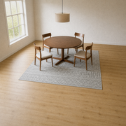 Dining room | the rug under a round table and chairs, light gray and white geometric pattern