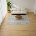 Living room | the rug in front of a gray sofa, light gray and white geometric pattern