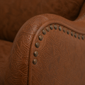Hardware detail | dark round nailhead trim on the brown embossed faux-leather arm front