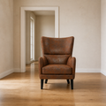 In scale | distressed brown embossed faux-leather wingback chair in front of an uncropped doorway reveal