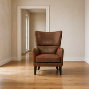In scale | distressed brown embossed faux-leather wingback chair in front of an uncropped doorway reveal
