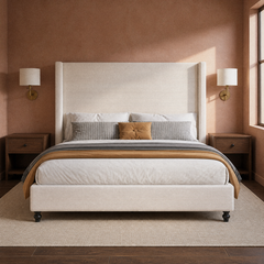 Room 3 | Front bedroom view with the white bed, paired brass sconces, warm wall, and rug
