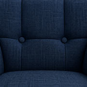 Tufting detail | close view of two dark upholstered buttons on the armchair's basketweave back