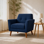 Room 1 | deep navy basketweave armchair in a warm white room with pale oak floor, left window, and round wood side table