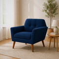 Room 1 three-quarter | deep navy basketweave armchair from a second angle in a warm white room with pale oak floor
