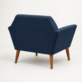 Studio side | rear-side view of deep navy basketweave armchair showing its plain outer back, side panel, and pecan birch legs