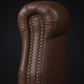 Hardware close-up | rolled arm with two rows of rounded brass-tone nailheads on reddish-brown distressed faux leather