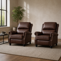 Room | two matching reddish-brown push-back recliners on a plain warm stone-gray rug in a greige loft with a tall window, showing rolled arms, nailhead trim and black bun feet