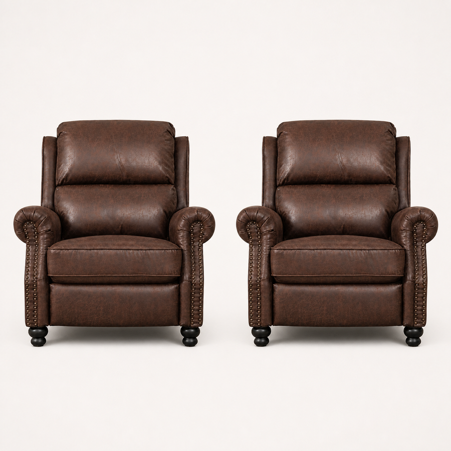 Front | two reddish-brown distressed faux-leather push-back recliners in a clean studio view, showing rolled arms, nailhead trim, loose seat cushions and black turned bun feet