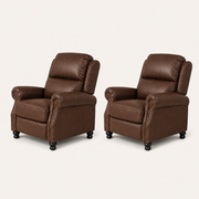 Three-quarter | two matching reddish-brown push-back recliners in a clean studio angle, showing side panels, rolled arms, nailhead trim and black turned bun feet