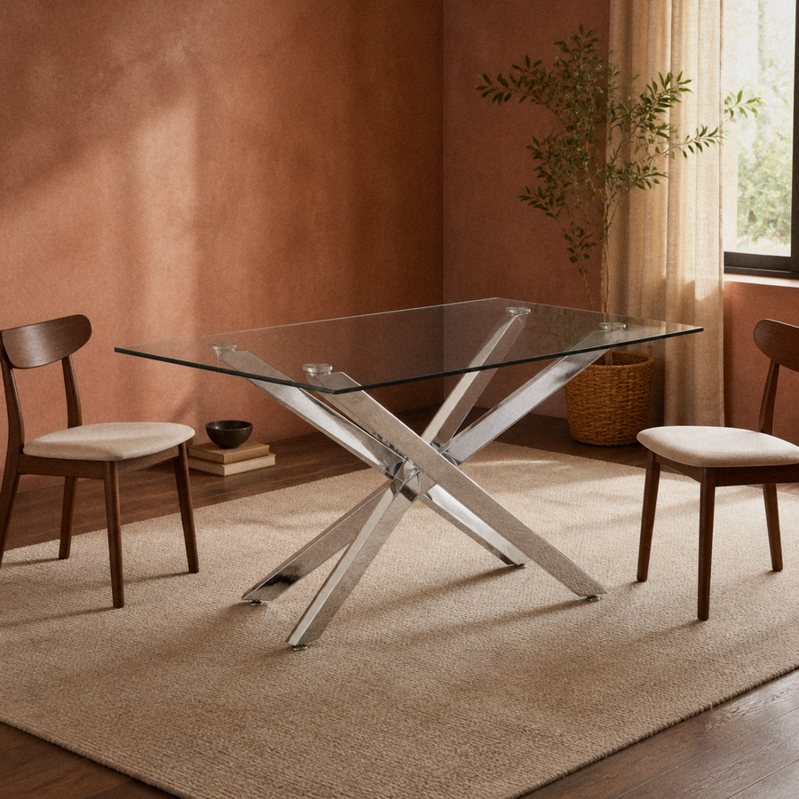 In a room | silver pedestal glass dining table in a warm clay-toned dining room with a plain rug