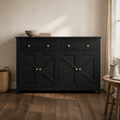 In a room | black sideboard with X-brace doors against an ivory plaster wall, dried branches by the window, warm afternoon light from the right