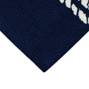Corner | a corner of the rug showing the tufted navy field and finished edge