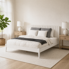 Room 2 angle | Pale bed viewed from a bright bedroom corner with a rug and wood flooring
