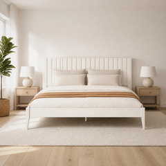Room 2 | Pale channel-panel bed in a bright bedroom with wood nightstands and a plant
