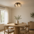 In a room | matte black hammered-glass flush mount over a round oak dining table