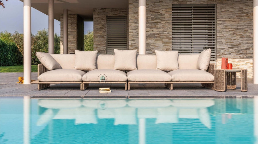 Custom modular outdoor sofa beside a pool at a stone villa