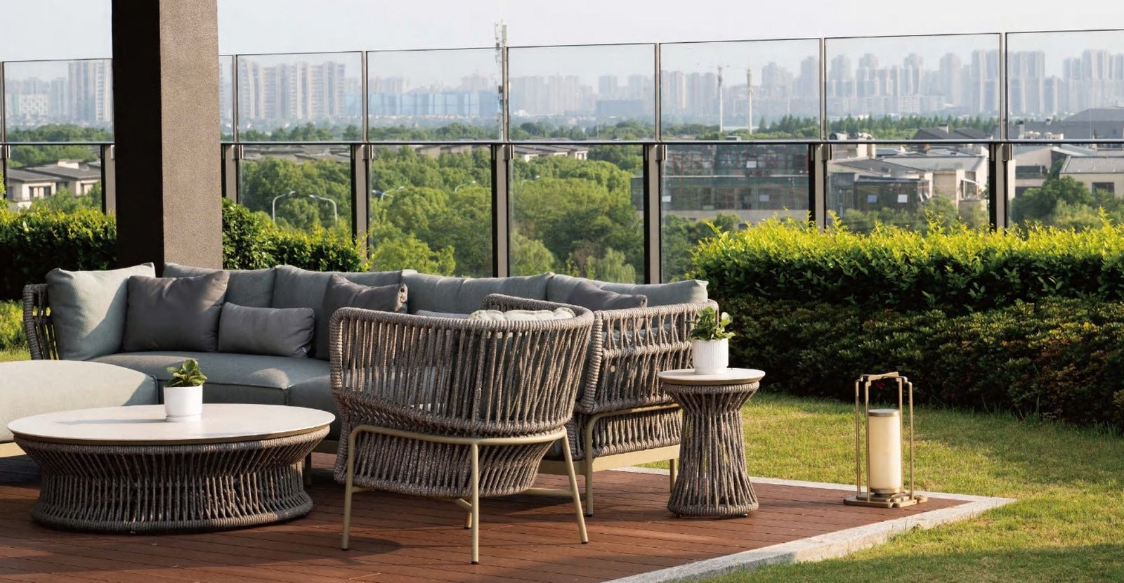 Rooftop terrace with a rope weave outdoor lounge set overlooking a city skyline
