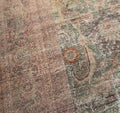 Texture | Close view of the low, faded pile and its floral drawing