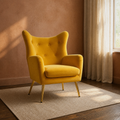 Room | mustard velvet wingback chair in a clay-toned room with dark wood floor and warm window light