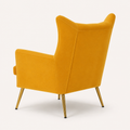 Side | upholstered back and wing profile of the mustard velvet chair with four tapered gold legs