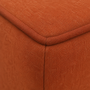 Cushion piping detail | Piped and stitched edge of the burnt-orange removable seat cushion