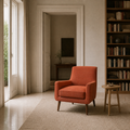 In scale | Burnt-orange armchair beside a full-height doorway in a library