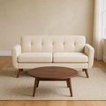 Sand room | Beige linen square-arm loveseat on an oatmeal wool rug in a warm sand-toned living room with a walnut coffee table and sheer curtains