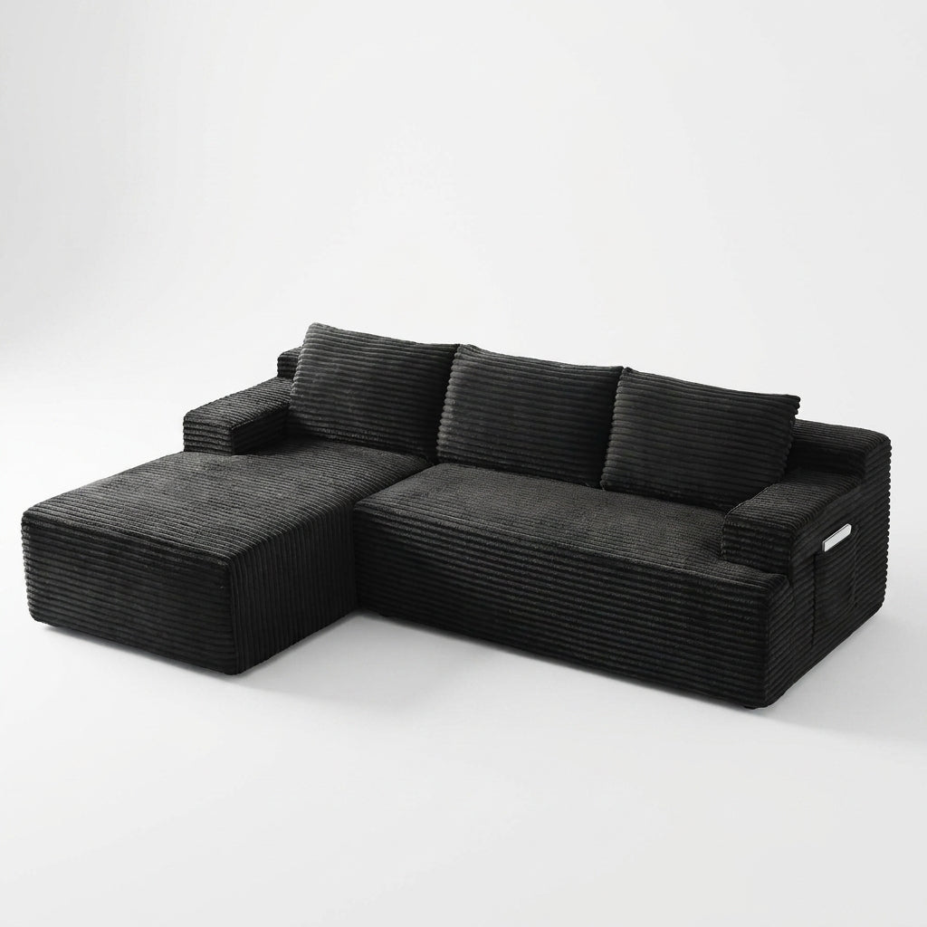 Front | Black corduroy sectional on a white studio backdrop with the chaise on the left