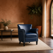 Terracotta room | Navy faux leather armchair beside an arched glazed doorway