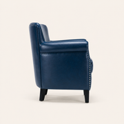 Studio side | Side profile of the navy faux leather armchair