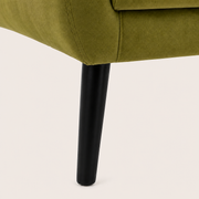Hardware | close view of a black tapered leg meeting the olive-green upholstered armchair base