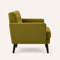 Side | true side profile of an olive-green velvet armchair showing its upholstered back, seat depth, square arm and black tapered legs