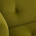 Texture | close view of olive-green velvet upholstery nap, a recessed tuft button and seam on the armchair