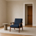 In scale | navy woven armchair beside a full-height interior doorway