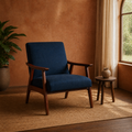 Room two | navy woven armchair in a terracotta room beside a small wood table