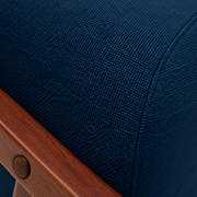 Material close-up | navy woven upholstery with visible crosshatch weave and cushion seam